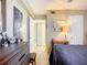 Cozy bedroom featuring a dresser and doorway, illuminated by a bedside lamp at 850 S Tamiami Trl # 207, Sarasota, FL 34236