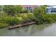 Scenic waterfront view with a private wooden dock, perfect for enjoying peaceful moments by the water at 850 S Tamiami Trl # 207, Sarasota, FL 34236