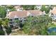 Aerial view showcasing the light gray condo building surrounded by lush trees and landscaping at 850 S Tamiami Trl # 207, Sarasota, FL 34236