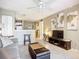 Comfortable living room with tile flooring, ceiling fan, and open access to the kitchen and dining area at 850 S Tamiami Trl # 207, Sarasota, FL 34236