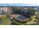 Community tennis court with mature manicured landscaping near ponds at 850 S Tamiami Trl # 207, Sarasota, FL 34236