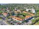 Panoramic aerial view of the condo community with a scenic pond, pool, and recreational facilities at 850 S Tamiami Trl # 730, Sarasota, FL 34236
