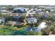 Aerial view of community featuring a tennis court, pool, pond and lush landscaping at 850 S Tamiami Trl # 730, Sarasota, FL 34236