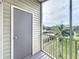 Screened balcony offers views of the tennis court, landscaping, and pond at 850 S Tamiami Trl # 730, Sarasota, FL 34236