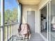 Cozy screened balcony with seating area and sliding glass doors to the living space at 850 S Tamiami Trl # 730, Sarasota, FL 34236