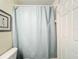 Cozy bathroom with a framed art piece and a shower featuring a light blue shower curtain for privacy at 850 S Tamiami Trl # 730, Sarasota, FL 34236