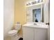 Cozy bathroom featuring a toilet, vanity with sink, and large mirror with adequate storage space at 850 S Tamiami Trl # 730, Sarasota, FL 34236
