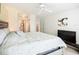 Spacious bedroom with ceiling fan features a large bed, TV, and access to ensuite bathroom and closets at 850 S Tamiami Trl # 730, Sarasota, FL 34236