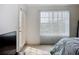 Bright bedroom with large window and balcony access offers natural light and comfortable living space at 850 S Tamiami Trl # 730, Sarasota, FL 34236