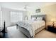 Bright bedroom featuring a decorative headboard, large windows, and ceiling fan, creating a relaxing space at 850 S Tamiami Trl # 730, Sarasota, FL 34236
