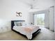 Bright bedroom features a sliding glass door to a balcony and neutral decor, perfect for relaxation at 850 S Tamiami Trl # 730, Sarasota, FL 34236