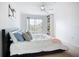 Bright bedroom with a sliding glass door to a balcony offering views and a modern ceiling fan at 850 S Tamiami Trl # 730, Sarasota, FL 34236