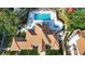 Aerial view of community pool and hot tub, with views of the clubhouse and landscaping at 850 S Tamiami Trl # 730, Sarasota, FL 34236