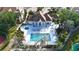Aerial view of the community clubhouse, hot tub, and pool with ample lounge seating at 850 S Tamiami Trl # 730, Sarasota, FL 34236