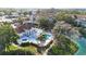 Aerial view of a hot tub, pool and deck, surrounded by mature trees and lush landscaping at 850 S Tamiami Trl # 730, Sarasota, FL 34236