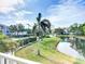 Scenic view of the lake, fountain, and tennis court in a well-maintained, landscaped community at 850 S Tamiami Trl # 730, Sarasota, FL 34236