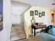Inviting entryway features carpeted stairs, a charming desk with moon-themed art, and warm yellow walls at 850 S Tamiami Trl # 730, Sarasota, FL 34236