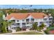 Charming condo building featuring screened balconies and lush landscaping in a well-maintained community at 850 S Tamiami Trl # 730, Sarasota, FL 34236