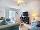 Well-lit living area with couches, a flat screen tv and a sliding door to the outside at 850 S Tamiami Trl # 730, Sarasota, FL 34236