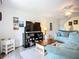 Bright living room featuring a large TV, display shelves, and comfortable couches at 850 S Tamiami Trl # 730, Sarasota, FL 34236