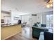 Open-concept living room featuring bar seating, eat-in kitchen, and comfortable furniture at 850 S Tamiami Trl # 730, Sarasota, FL 34236
