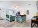 Spacious living room with a large TV, bright natural light, and comfortable couches at 850 S Tamiami Trl # 730, Sarasota, FL 34236