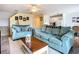Living room with cozy seating, neutral walls, and a view into the bright kitchen at 850 S Tamiami Trl # 730, Sarasota, FL 34236
