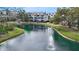 Picturesque pond with fountain, surrounded by lush greenery and condominium buildings at 850 S Tamiami Trl # 730, Sarasota, FL 34236