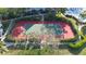 Aerial view of a tennis court surrounded by mature trees offering a shaded court setting at 850 S Tamiami Trl # 730, Sarasota, FL 34236