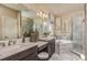 Bathroom featuring dual vanities, a soaking tub, and a separate walk-in shower with marble surround at 8550 Big Dipper Dr, Sarasota, FL 34241