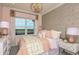 Stylish bedroom with a gold chandelier, patterned wallpaper, and plenty of natural light at 8550 Big Dipper Dr, Sarasota, FL 34241