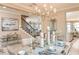 A dining room table set for a meal, with stairs and a kitchen visible in the background at 8550 Big Dipper Dr, Sarasota, FL 34241
