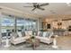 Open-concept living room with a large sectional, kitchen view, and backyard views at 8550 Big Dipper Dr, Sarasota, FL 34241