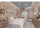 A serene bedroom with a blue ceiling, decorative light fixtures, and neutral decor at 8550 Big Dipper Dr, Sarasota, FL 34241