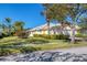 Charming single-story home with a well-manicured lawn, lush landscaping, and a neutral color palette at 8851 Etera Dr, Sarasota, FL 34238