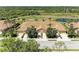 Overhead view of townhomes with two-car garages along a street with golf course and pond in the background at 9121 Stone Harbour Loop, Bradenton, FL 34212