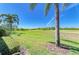 Lush backyard overlooking a golf course, enhanced by palm trees and green foliage at 9121 Stone Harbour Loop, Bradenton, FL 34212