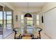 Bright breakfast nook with a glass table, bay window and serene view at 9121 Stone Harbour Loop, Bradenton, FL 34212