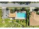 A top-down view of a community pool, surrounded by lush landscaping and palm trees, providing a serene retreat at 9121 Stone Harbour Loop, Bradenton, FL 34212
