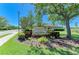 Stone Harbour community entrance sign with landscaping and coach homes in the background on a bright, sunny day at 9121 Stone Harbour Loop, Bradenton, FL 34212