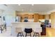 Kitchenette featuring a breakfast bar with seating, stainless steel appliances, and custom wood cabinetry at 9121 Stone Harbour Loop, Bradenton, FL 34212