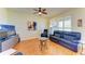 Living room with hardwood floors, black leather furniture, and large windows with shutter-style blinds at 9121 Stone Harbour Loop, Bradenton, FL 34212