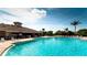 Community pool with inviting, turquoise water and comfortable lounge chairs for relaxing poolside at 9121 Stone Harbour Loop, Bradenton, FL 34212