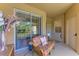 Cozy covered porch with comfortable seating and sliding glass doors to the interior at 9121 Stone Harbour Loop, Bradenton, FL 34212