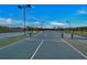 View of several tennis courts with lighting on a sunny day within the community at 9121 Stone Harbour Loop, Bradenton, FL 34212