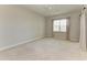 Cozy bedroom with plush carpeting, window with curtains, and ceiling fan at 9429 Discovery Ter # 102B, Bradenton, FL 34212