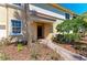 Charming home entrance with a brick walkway, a manicured garden, and a neutral-toned exterior at 9429 Discovery Ter # 102B, Bradenton, FL 34212