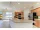 Well-lit kitchen boasts stainless steel appliances, ample counter space, and wooden cabinetry at 9429 Discovery Ter # 102B, Bradenton, FL 34212