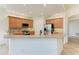 Kitchen features stainless steel refrigerator, backsplash, wooden cabinets, and lots of counter space at 9429 Discovery Ter # 102B, Bradenton, FL 34212