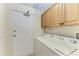 Laundry area featuring modern appliances and ample storage at 9429 Discovery Ter # 102B, Bradenton, FL 34212
